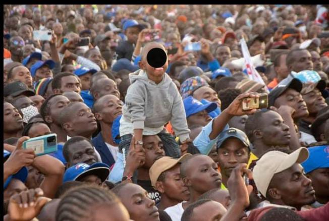 A photo of a child in a political rally crowd