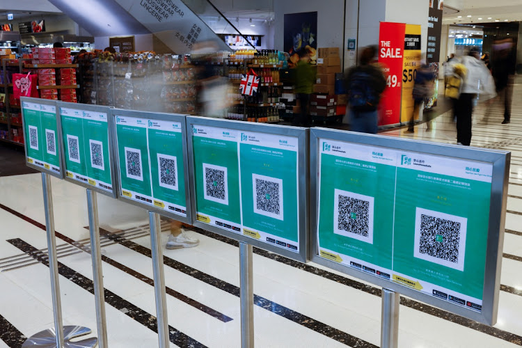 QR codes for the "LeaveHomeSafe" Covid-19 contact-tracing app are seen outside a shopping mall at the first day of a vaccine passport roll out, following the coronavirus disease (COVID-19) outbreak, in Hong Kong, China, February 24, 2022.