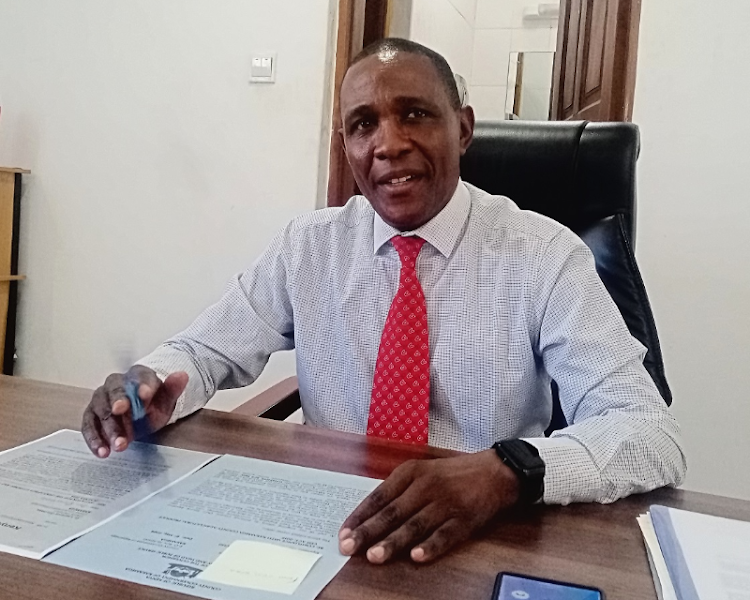 Kakamega county secretary Lawrence Omuhaka speaking to journalists in his office on Friday