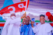 FILE PHOTO: APC party's new presidential candidate Bola Tinubu raises a party's flag with Nigeria's President Muhammadu Buhari next to Abdullahi Adamu, the APC party chairman, during the party convention in Abuja, Nigeria June 7, 2022. 