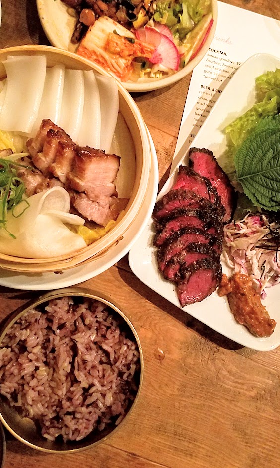 Han Oak Ssam course with Ember Smoked Hanger Steak with lettuces, perilla, chrysanthemum, cabbage slaw, and ssam-jang and then Koji Marinated Slow Roasted Pork Belly and Coppa with rice noodle sheets, pickled daikon, and scallion salad