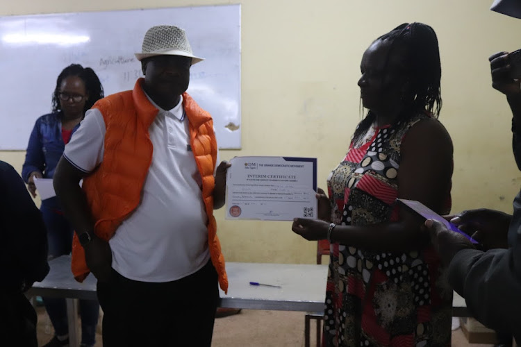 Ndhiwa MP Martin Owino receives provisional certificate after from CRO Caroline Angote after winning in ODM party primaries on April 15, 2022