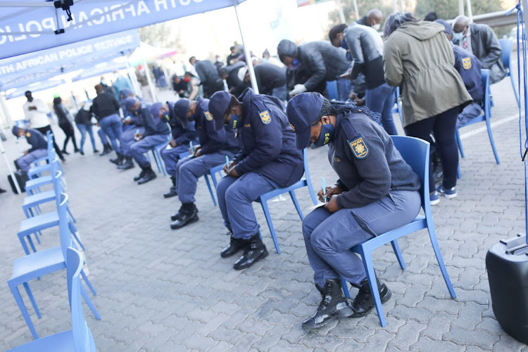 Members of the South African Police Service register their details ahead of receiving the vaccine for Covid-19, 05 July 2021, at Orlando Stadium, Soweto, Johannesburg. Vaccinations have opened to members of the police as part of the governments vaccine rollout program.