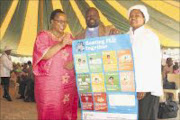 KNOWLEDGE IS POWER: The KwaZulu-Natal heath department has embarked on a campaign to educate people on how to curb the spread of the H1N1 influenza virus. From left: Health department head Sibongile Zungu with Reverend Bhekubuhle Dlamini and his wife Sindisiwe, at Newtown B in Inanda. PIC: THEMBA MNGOMEZULU. 07/09/2009. © Sowetan.