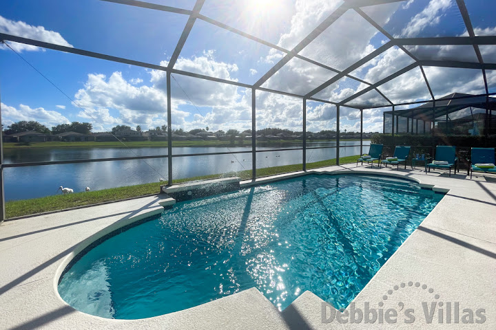 Gorgeous lake view for the sun drenched pool deck at this Sunset Lakes vacation villa