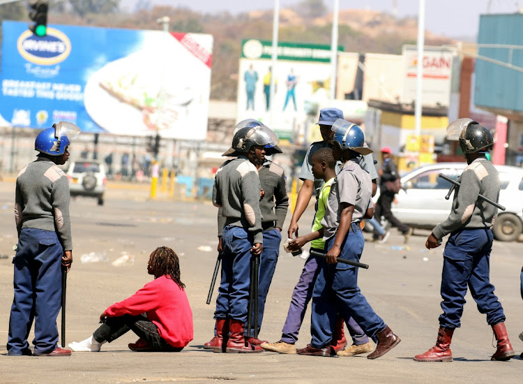 Riot police detain protesters during clashes after police banned protests called by the opposition Movement for Democratic Change party in Harare, Zimbabwe, on August 16 2019.