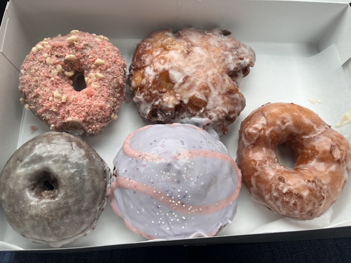 Back Left: Strawberry Shortcake, Apple Fritter. Front Left: Chocolate Glaze, Strawberry Lavender Filled(daily special), Maple Glazed Raised(my fave)