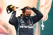 Lewis Hamilton of Great Britain and Mercedes GP celebrates winning a seventh F1 World Drivers Championship on the podium during the F1 Grand Prix of Turkey at Intercity Istanbul Park on November 15, 2020 in Istanbul.