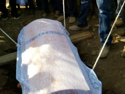 Mourners lower the casket containing the hand of a missing 11-year old boy in Baringo county on Saturday, February 9, 2019. /JOSEPH KANGOGO