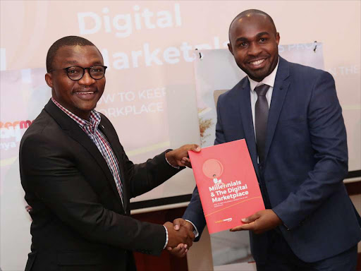 Youth Enterprise Fund chairman Ronald Osumba with Brighter Monday Kenya CEO Emmanuel Mutuma exchange the Millennials and the Digital market place report in Nairobi on February 12 /ENOS TECHE