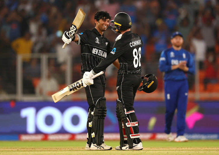 New Zealand's Rachin Ravindra celebrates after reaching his century with Devon Conway in their 2023 ICC Cricket World Cup match against England at Narendra Modi Stadium in Ahmadabad, India on Thursday.