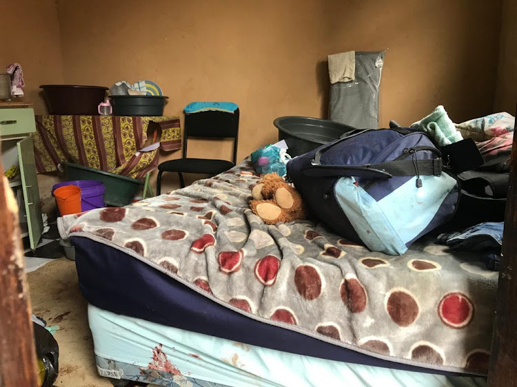 The room in a Phoenix house where a woman and her two-year-old daughter were hacked to death. A 62-year-old man has been arrested in connection with the deaths.