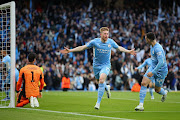 Kevin De Bruyne of Manchester City celebrates scoring their opening goal with Phil Foden in the Uefa Champions League semifinal first leg match against Real Madrid at City of Manchester Stadium on April 26 2022.