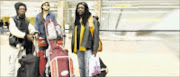 AT A LOSS: Band members of Miriam Makeba, Mandla Zikalala, left, Joel Klein, centre , and Zamokuhle Mbutho, at OR Tambo International Airport after arriving from Italy. Their tour was cut short after Makeba collapsed and later died of a heart attack.  11/11/2008. Pic Mohau Mofokeng.  © Sowetan