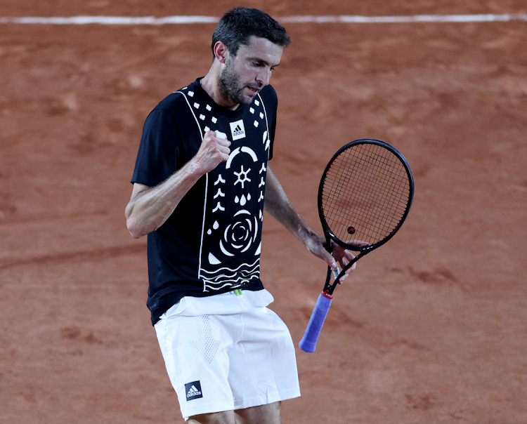 France's Gilles Simon reacts during his first round match against Spain's Pablo Carreno Busta