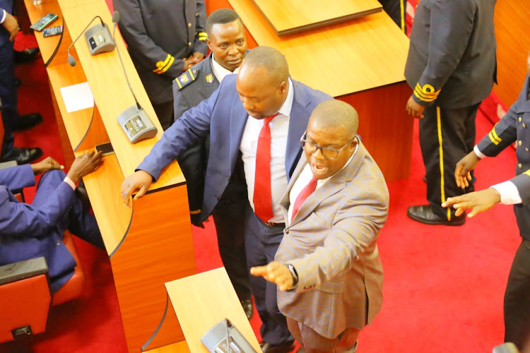 Naftal Onkoba (Nyacheki) and Richmond Manani (Bigeka) trying to calm temperatures in the house as members exchanged during the tabling of a motion to kick out Deputy Governor Robert Monda (IMAGE BY MAGATI OBEBO)
