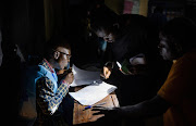 An Independent National Electoral Commission agent processes voters at the Mavuno polling centre during the Presidential election in Goma, North Kivu province of the Democratic Republic of Congo.