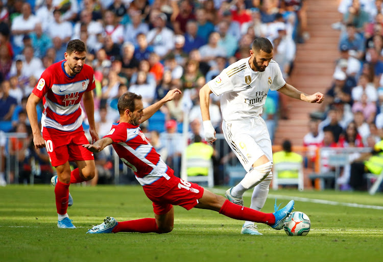 Granada's Victor Diaz in action with Real Madrid's Karim Benzema