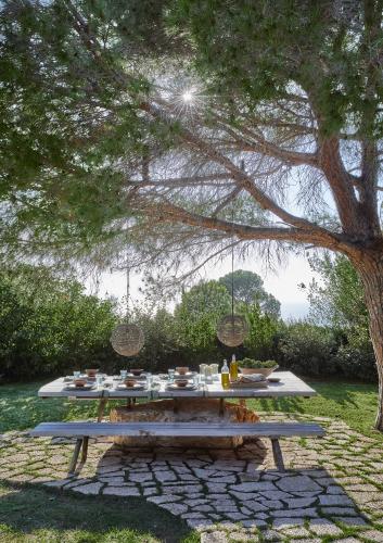 Tucked discreetly away behind a stone wall in a lush, landscaped garden, this island holiday home is a perfectly private retreat for its celebrity owners, who love to linger over meals in this outdoor dining area.