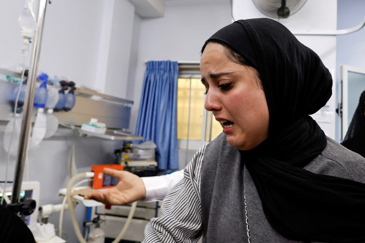 A relative reacts at a hospital after a Palestinian woman was killed in an incident at an Israeli checkpoint, in Hebron in the Israeli-occupied West Bank, June 1, 2022.