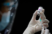 A health worker prepares a dose of AstraZeneca COVID-19 vaccine against the coronavirus disease (Covid-19) as Thailand start mass inoculation at a gymnasium inside Siam Paragon shopping centre, Bangkok, Thailand June 7, 2021. 