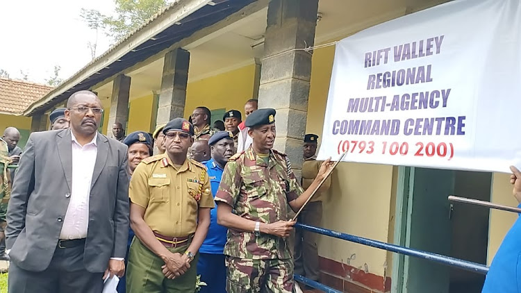 Officers and Rift Valley regional commissioner Maalim Mohamed (right, with pointer) during the opening of a multi-agency election command centre in Nakuru