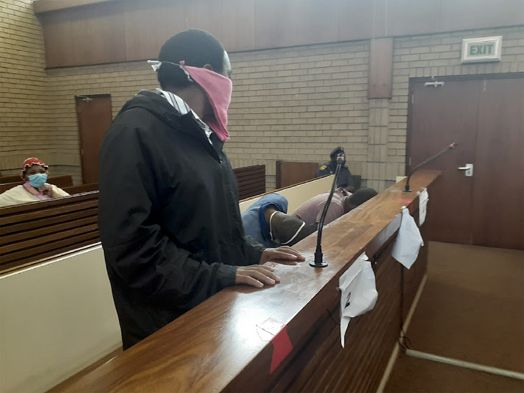 Thokozani Msibi, in the pink mask, on Wednesday told the high court in Middelburg that he does not know how Gabisile Shabane's body parts ended up in his indumba. File photo.