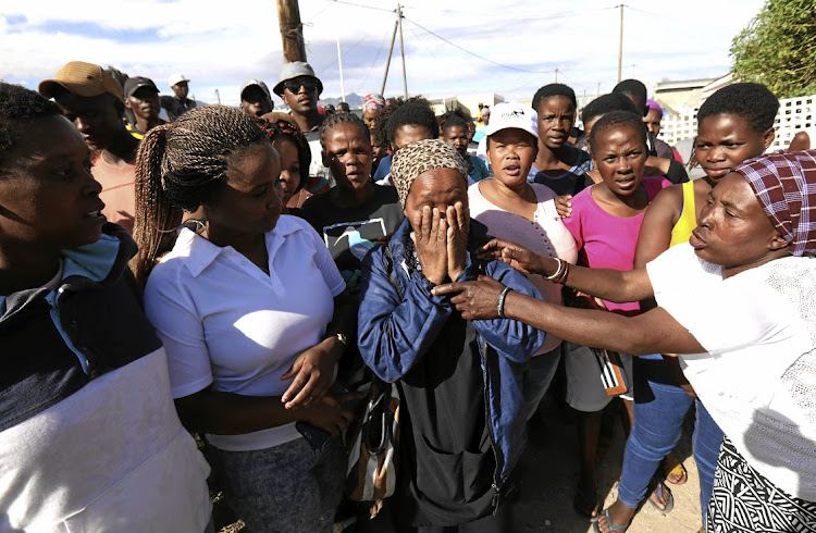 Nomaza Nomandela, centre, was part of a group of protesters who invaded land in Hermanus. She also received an SMS demanding she pay rates.