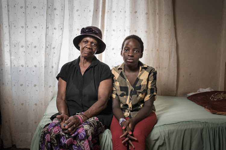 Social grant recipient Maolaotse Grace Bonokwane, pictured with her granddaughter, was refunded for airtime deducted from her Sassa-branded bank account without her permission. PICTURE: THOM PIERCE