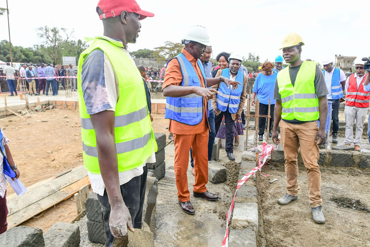 President William Ruto with workers at the Nanyuki Affordable Housing Project in Laikipia East Constituency on January 10, 2023.