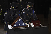 U.S. Capitol Police Officers place the remains of officer Brian Sicknick in the Capitol Rotunda of  the U.S. Capitol in Washington, D.C., U.S., on Tuesday, Feb. 2, 2021. 