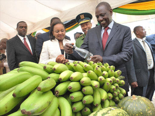 Deputy president Willam Ruto with Devolution CS Ann Waiguru and Sport and Culture CS Hassan Wario at an exhibition stand during the National Youth Service convention at Kasarani. Photo/DPPS