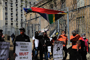 A group of protesters outside the Johannesburg court where six suspects were appearing in connection with the murder of Gauteng health department whistleblower Babita Deokaran.