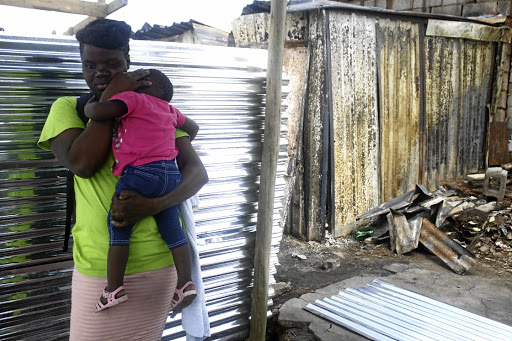 A woman comforts a child.