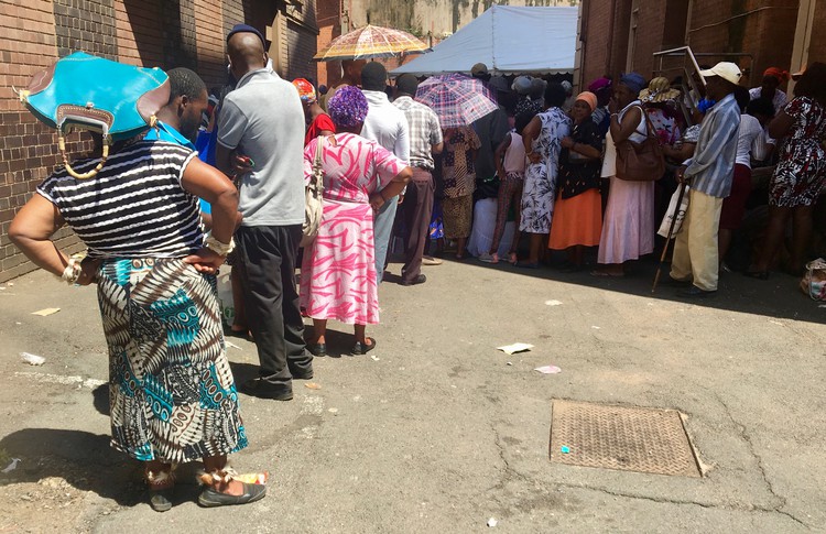 There are no chairs and a lack of toilets for the long queues of people at Pietermartizburg post office.