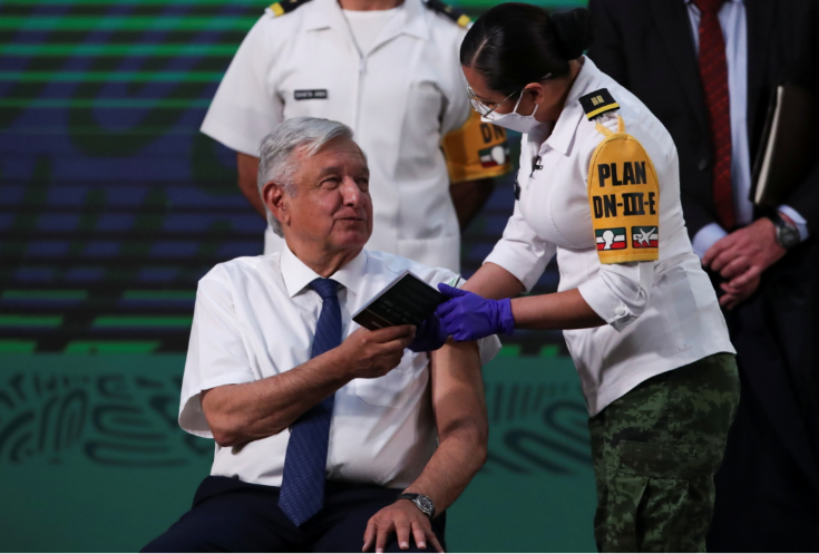 Mexico's President Andres Manuel Lopez Obrador holds a card of vaccination after receiving a dose of the AstraZeneca coronavirus diseasevaccine during a vaccination at the National Palace in Mexico City, Mexico on April 20 2021.