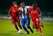 Maritzburg United midfielder Miguel Timm is sandwiched by Orlando Pirates' right-back and Mthokozisi Dube (R) and winger Luvuyo Memela during a 1-0 Absa Premiership win at Harry Gwala Stadium on April 24 2019.