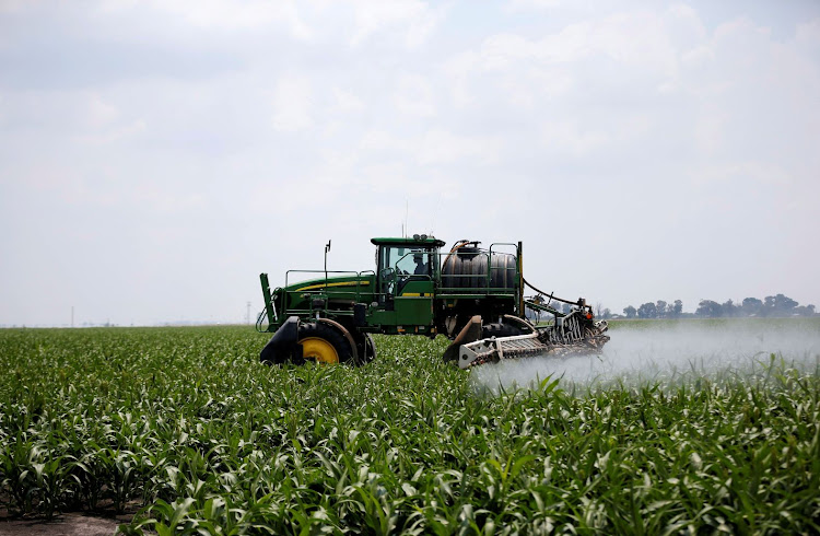 A worker uses a John Deere tractor to spray crops at a farm in Settlers, Limpopo. Picture: REUTERS/SIPHIWE SIBEKO