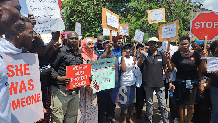 Kisumu residents holds a placard during to protest against the increased number of femicides experienced across the country on January 27, 2024