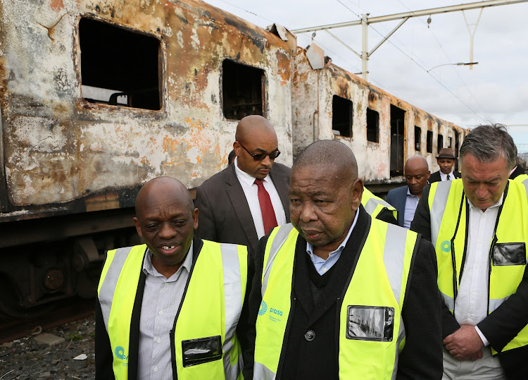 Transport Minister on a visit to the burnt trains in Cape Town.