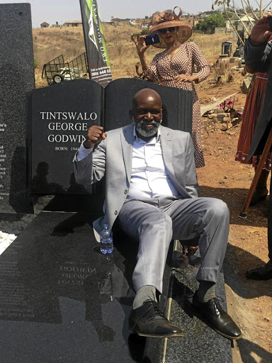 George Mashamba sitting on his tombstone at the weekend.