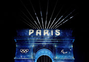 'Paris' is projected onto the Arc de Triomphe to celebrate entry into the Olympic year during New Year's celebrations on the Champs Elysees avenue in Paris. Public transport agents will use AI-supported translation devices to help hundreds of thousands of visitors navigate the French capital's network during the 2024 Olympic Games. File photo. 