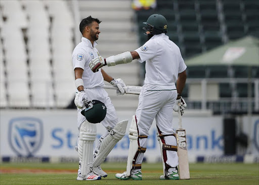 South African batsman JP Duminy (L) is congratulated for his Century by Hashim Amla during the third Test between South Africa and Sri Lanka on January 12, 2017 at Wanderers Cricket Stadium in Johannesburg.