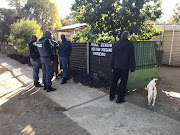 Police outside the house in Pretoria’s Swemmer street where firearms were seized during a raid.