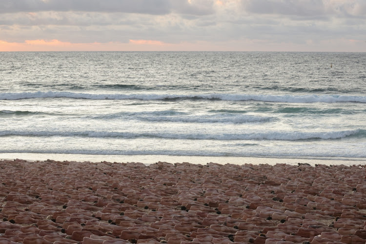 People lie naked on Bondi Beach, Australia, as part of artist Spencer Tunick's art installation to raise awareness of skin cancer and encourage people to have their skin checked.