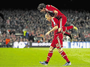 Bayern Munich's Javi Martinez leaps over teammate Arjen Robben in celebration of the latter's goal against Barcelona during their Champions League semifinal second leg match at Camp Nou last night. The Germans are in the final after a 7-0 aggregate win