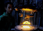 A boy works for $3 per day during his school holidays to assist his family, at a glass factory in Cairo. 