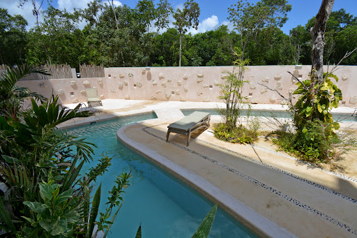 Outdoor pool with lounge chairs and lush vegetation - Buy this luxury apartment / penthouse in Tulum