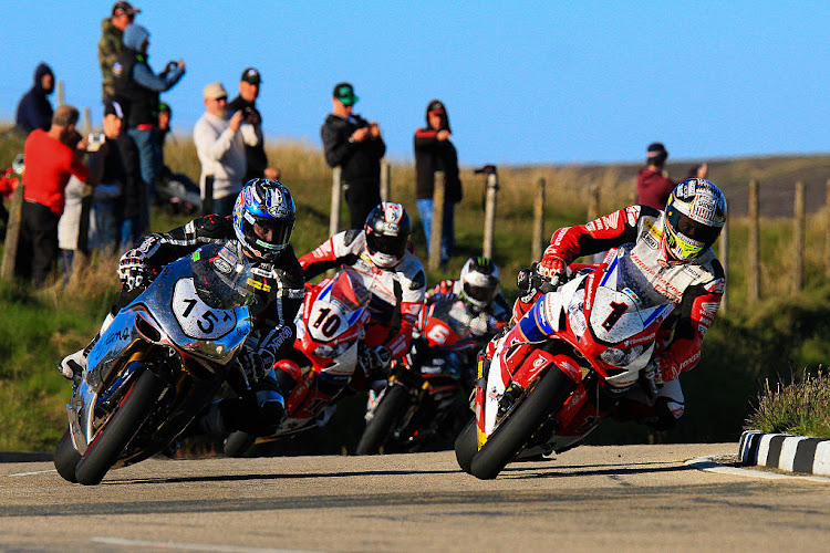 John McGuiness leads David Johnson, Coner Cummins and Michael Dunlop over the mountain section during an evening practice at The Isle of Man TT races on June 2 2016 in Douglas.