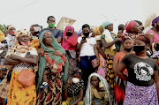 People wait for friends and relatives as a ship carrying more than 1,000 people fleeing an attack claimed by Islamic State-linked insurgents on the town of Palma, docks in Pemba, Mozambique, on April 1. 